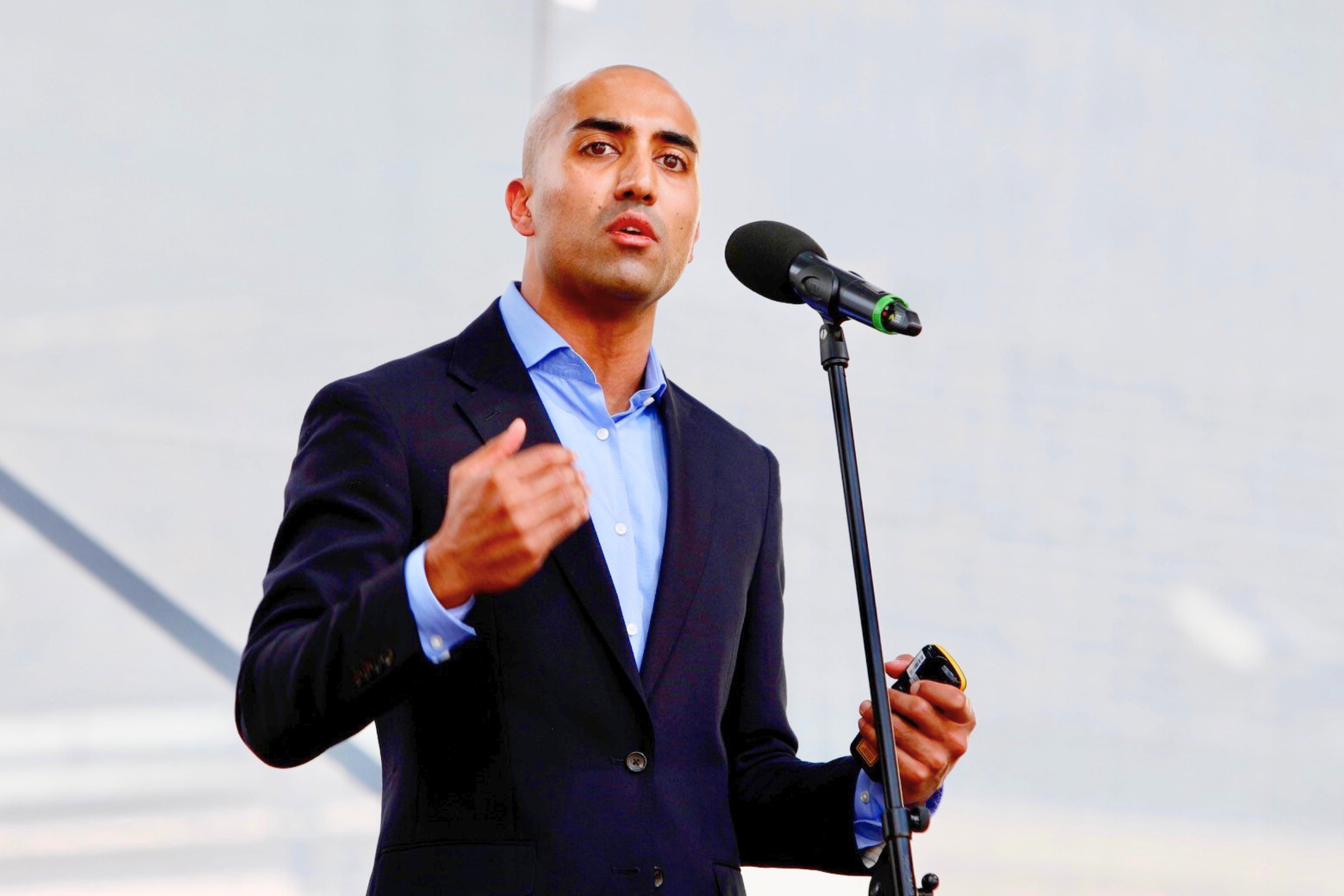 Abishur Prakash speaking on stage
